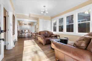 a living room with leather furniture and a dining room at The Grand on Garden in Coeur d'Alene