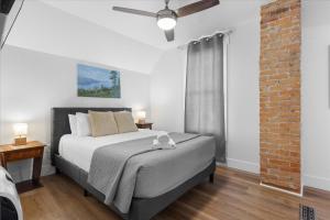 a bedroom with a bed and a brick wall at The Grand on Garden in Coeur d'Alene