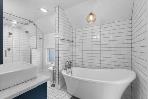 a white bathroom with a tub and a sink at The Grand on Garden in Coeur d'Alene +41 photos