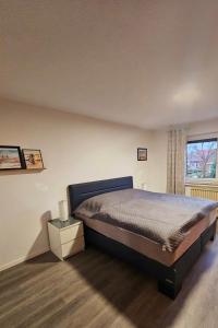 a bedroom with a large bed and a window at Haus-Alter in Wilhelmshaven