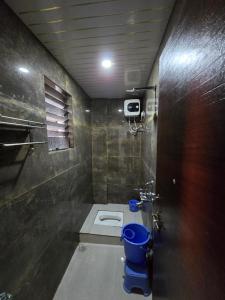a bathroom with a toilet in a room at Shree Shiv bhakt niwas in Tuljapur
