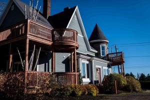 a house with a deck on the front of it at Château Queen by Bower Boutique Hotels in Moncton