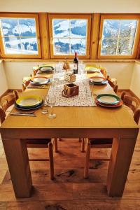 プルークガーンにあるApartment Kulmer Hof by Interhomeの皿とグラスが置かれた木製のテーブル