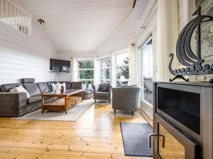 a living room with a couch and a table at Holiday Home Sjøbuvågen by Interhome in Korssund