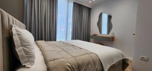 a hotel room with a bed and a mirror at Villa MarYsol - San Pietro Resort - Pool & Hot Tub in Durrës