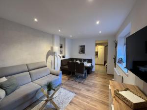 a living room with a couch and a dining room at Apartment Stefanie by Interhome in Taxenbach