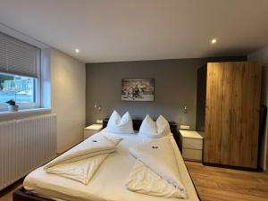 a bedroom with a large bed with white pillows at Apartment Stefanie by Interhome in Taxenbach