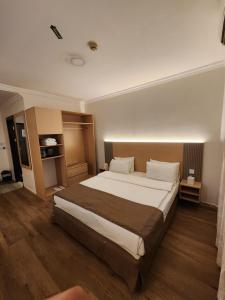 a bedroom with a large bed in a room at Sharjah International Airport Hotel in Sharjah