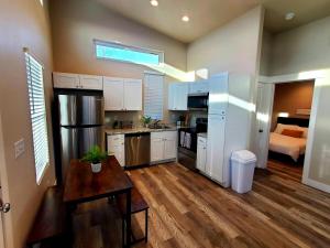 a kitchen with white cabinets and a table and a bed at Hidden Gem! Private Guest Home in Syracuse
