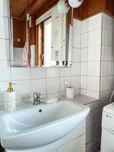 a bathroom with a white sink and a mirror at GreenHill House in Kaunas +61 photos