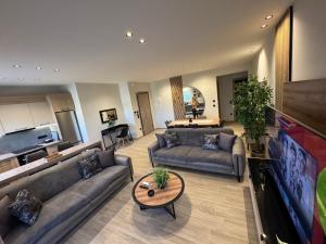 a large living room with couches and a table at Apartimo B2 in Alexandroupoli