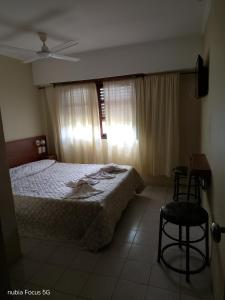 a bedroom with a bed and a table and chairs at HOTEL SAN JORGE in San Clemente