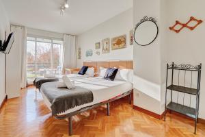 A bed or beds in a room at Mirasierra Suites Pamplona