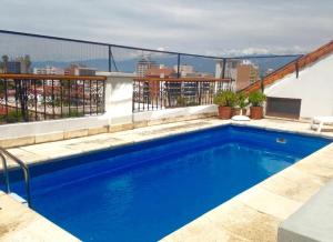a large blue swimming pool on top of a building at Solar De La Plaza in Salta
