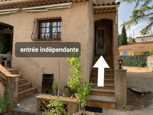 a house with a sign that reads entrance independence at Chez Pierre in Le Val