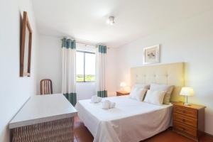 a bedroom with two beds and a window at Algardia Marina Parque by Garvetur in Vilamoura +48 photos