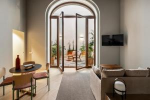 a living room with a couch and a table at Mercer Residences Sevilla in Seville