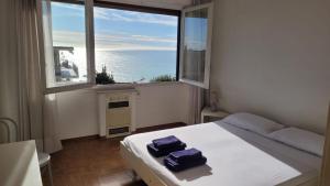 a bedroom with a bed and a large window at Vista Bella House in Sanremo
