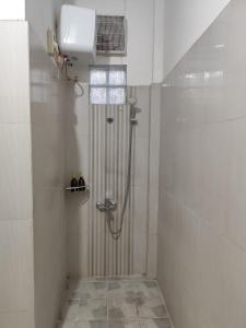 a shower stall in a bathroom with a shower at Kadipiro Homestay in Ngabean