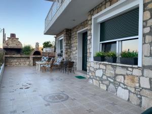 a patio with chairs and a table and a window at Apartment in Kinira Thasos in Koinyra +9 photos