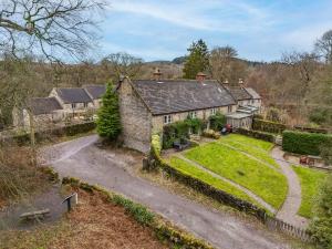 an estate with a stone house and a driveway at Primrose Cottage in Matlock
