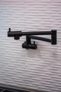 a black towel rack on a white wall at Spacious 4BR, Pool, Jacuzzi, Pickleball, Sauna, Cold Plunge in Desert Hot Springs