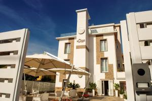 a building with a clock tower in front of it at La Cicas Case Vacanze in Marina di Ascea