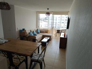 a living room with a couch and a table at Los Molles apartment in Los Molles