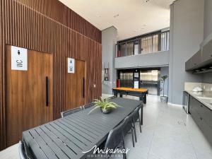 a dining room with a table and a ping pong ball at Simple Smart Residence in Tambaú