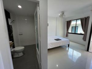 a small bathroom with a bed and a toilet at Patong Easy life 5 in Patong Beach