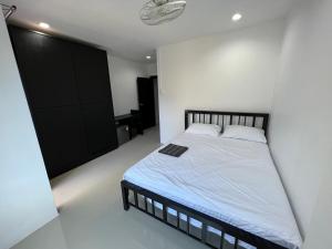 a bedroom with a bed and a black closet at Patong Easy life 5 in Patong Beach