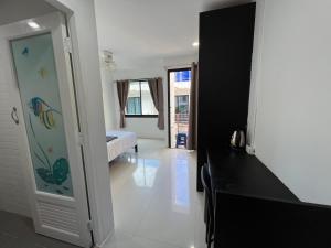 a room with a bedroom with a bed and a mirror at Patong Easy life 5 in Patong Beach