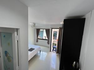 a bedroom with a bed and two windows at Patong Easy life 5 in Patong Beach