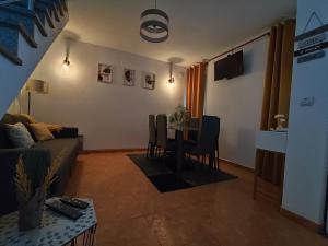 a living room with a couch and a table at Areal Guest House in Figueiró dos Vinhos