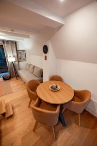 a living room with a wooden table and chairs at Zlatar mountain retreat in Nova Varoš +13 photos