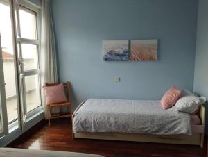 a bedroom with a bed and a large window at Apartment Aire del Mar in Liencres