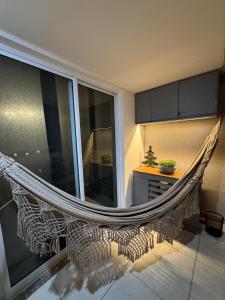a hammock in the middle of a room at Fabuloso - Brisas do Lago in Brasília +33 photos