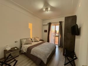 a bedroom with a bed and a television in it at B&B il Rio in Anacapri