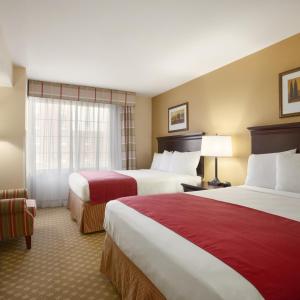 a hotel room with two beds and a window at Spark by Hilton Washington Meadowlands Blvd in Washington +21 photos