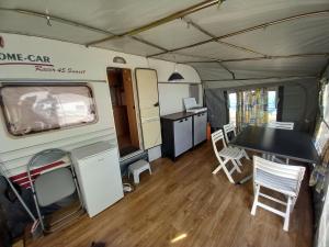 an interior view of an rv with a table and chairs at Caravan near the sea 4 in Ugljan