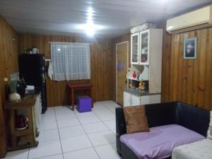 a living room with a couch and a kitchen at Inature in Florianópolis +18 photos