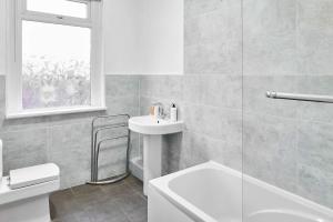 a white bathroom with a sink and a toilet at Host & Stay - Thurstane Street in Bolton