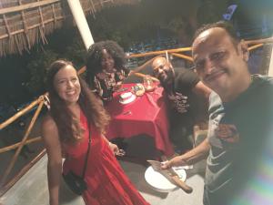 a group of people posing for a picture at a table at Zanzi beach hotel in Nungwi