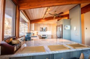a kitchen with a ceiling fan and a large counter top at Pinnacle Ridge Sunrise Sunsets in Beech Mountain +26 photos