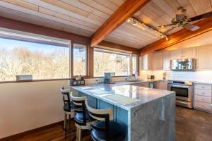 a kitchen with a large island with a counter top at Pinnacle Ridge Sunrise Sunsets in Beech Mountain