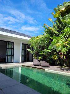 a swimming pool in front of a villa at Tranquil 2BR Pool Villa - Fast WiFi - Work-Friendly - Near Echo Beach in Tumbak Bayuh