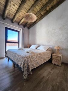 a bedroom with a bed and a large window at fuerte trece in Encinasola +45 photos