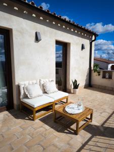 a patio with a couch and a coffee table at fuerte trece in Encinasola