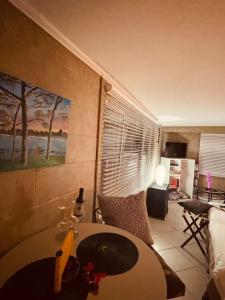 a living room with a bed and a table in a room at Small piece of heaven on the lake - King suite in Richfield