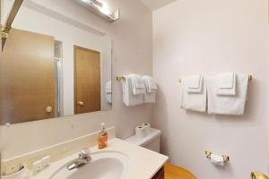 a white bathroom with a sink and a mirror at Dollar Hill 2 Dreamcatcher in Dollar Point +18 photos